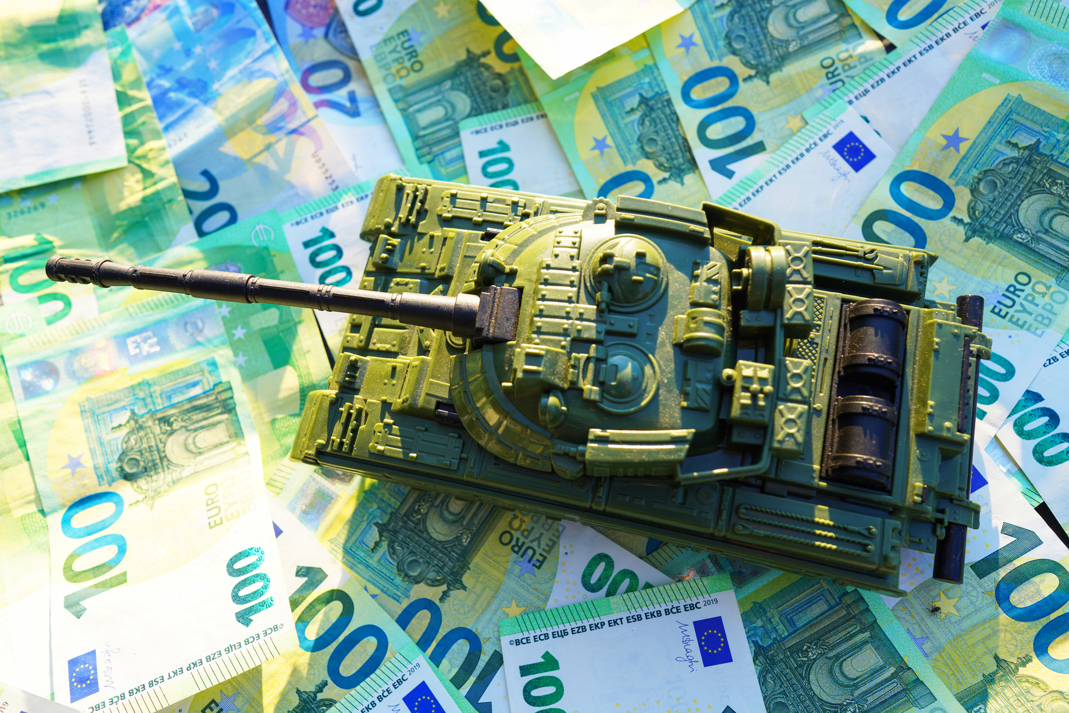 Tank on background of banknotes. Currency war. War costs, military spending. Making money from war. Money laundering on War. Military economy. Military tank and European banknotes. Weapons trade.