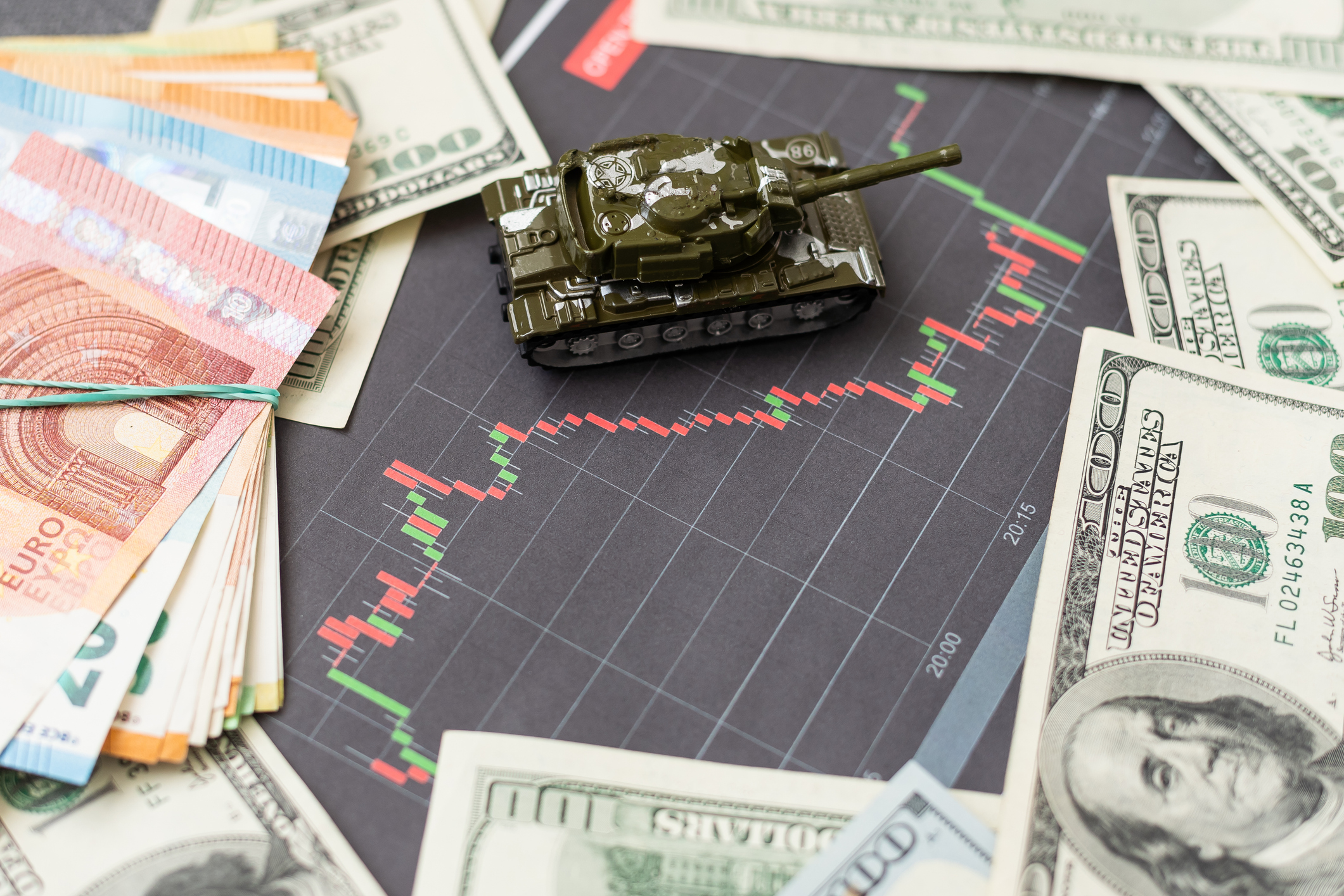 a toy tank, dollars and a tablet. High quality photo